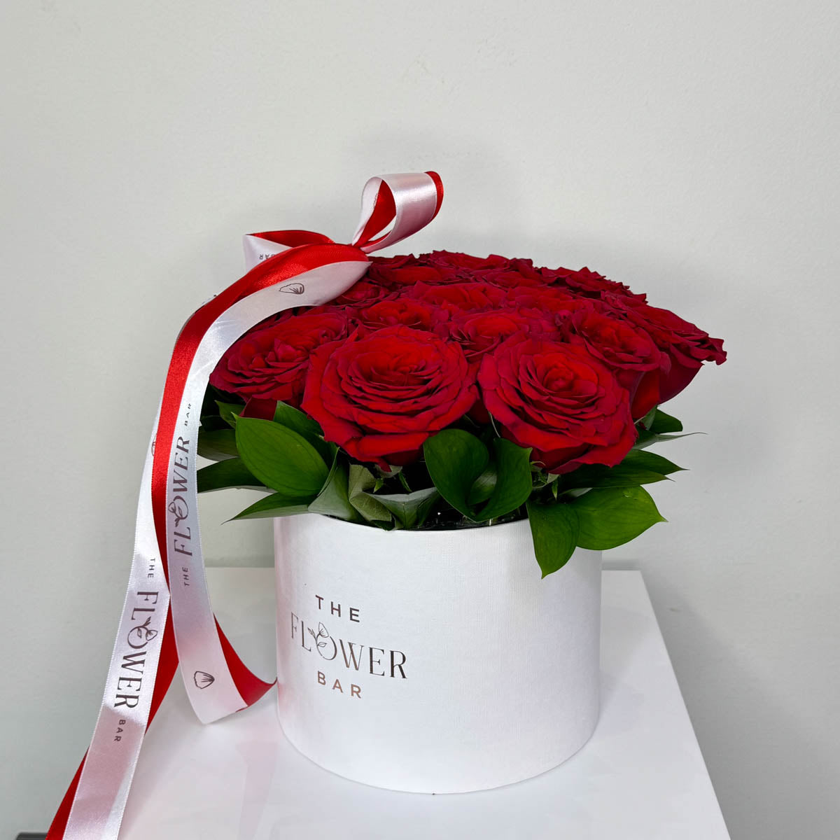 White round box in 19 red roses