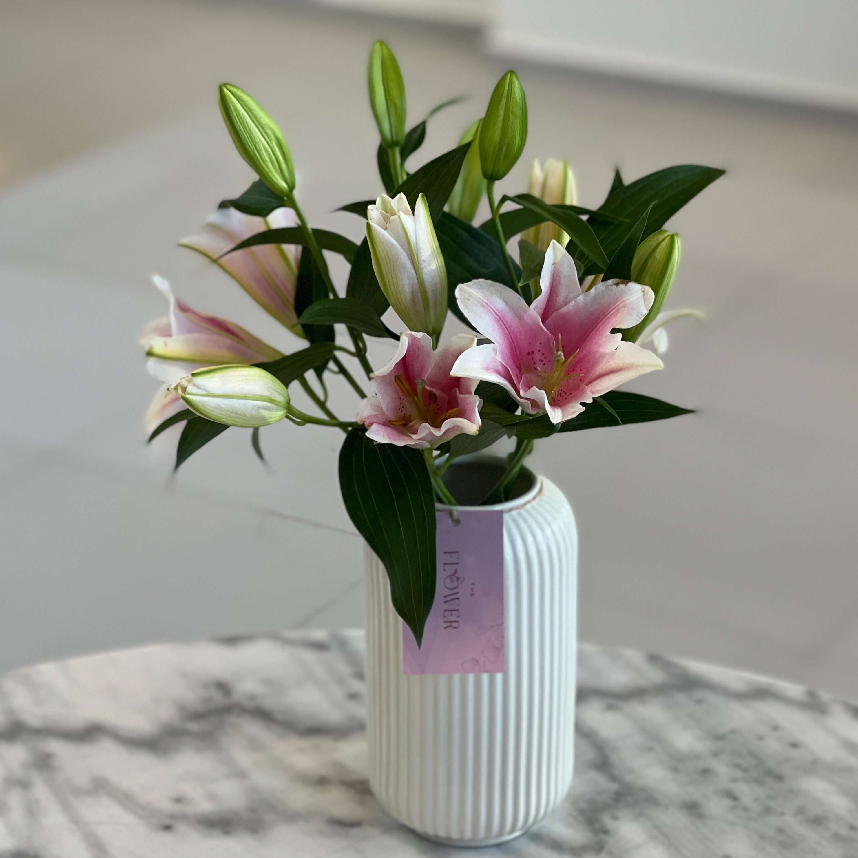 Lilies In White Vase